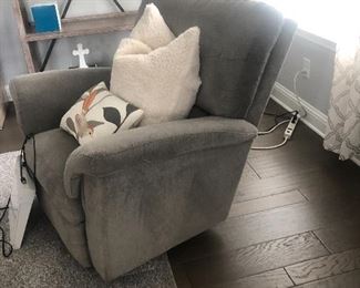 There are two of these gray velvet reclining chairs