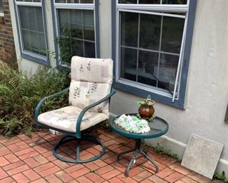 Just a few outdoor furniture pieces and out door items on patio.