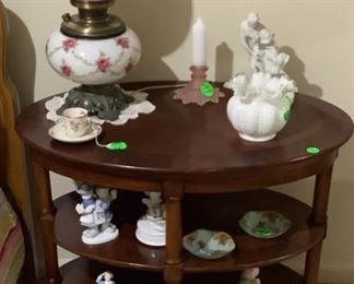 Antique lamp on table with several collectible pieces in end table.  Great 3 shelf end table.