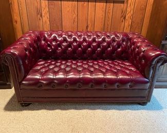 Hancock & Moore Chesterfield burgundy leather upholstered loveseat. Measures 65" W x 35" D. Photo 1 of 2.