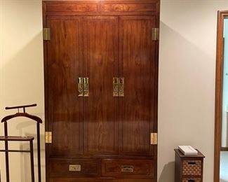 A Henredon Scene One campaign armoire. Features three upper cabinets and four lower dovetailed drawers. Accented with brass pulls and brackets. 40.0" W x 81.75" H x 18.0" D. 