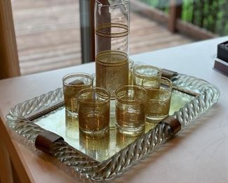 Set of 6 limoncello glasses and pitcher on antique mirrored glass tray with brass detailing.