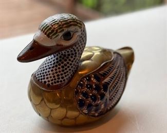 Brass and painted wood duck.