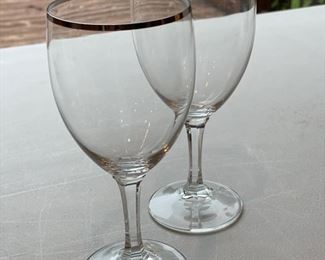 Gold-rim wine glasses.