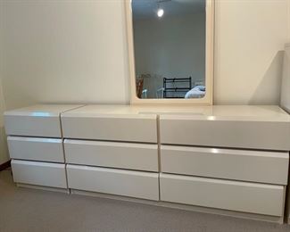 Vintage mid-century 6-drawer bureau with mirror by Lane Furniture. The bureau is finished in a rich, creamy pearl lacquer over heavyweight, solid wood - 2 shown (pictured with second side table for platform bed). Each measures 68" W x 18" D x 30" H. Photo 1 of 2.