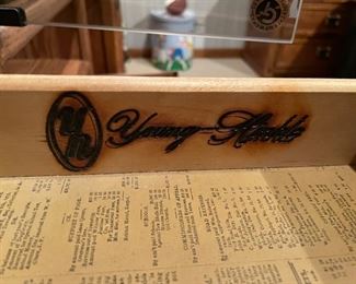 1980s Craftsman style oak desk with hutch and chair from the Young-Hinkle Windjammer collection. The desk has a brown leatherette top and features three stacked drawers beside a kneehole with a single drawer above; the drawers have brass pulls and are lined in faux newspaper. Desk measures 44.5" W x 30.0" H x 20.0" D. Hutch measures 44" W x 46" H x 10" D. Photo 2 of 2.