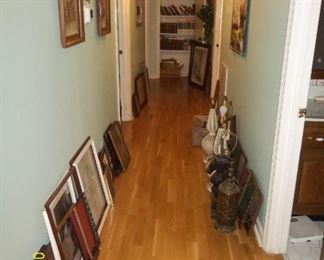 lots of pictures, paintings, wooden frames