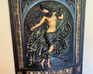 This beautiful piece of art is actually cast iron and would have been used to cover a fireplace opening. 