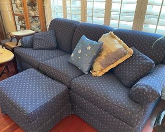 Beautiful upholstered in navy with cream accent detail sofa with pull out bed and foot stool