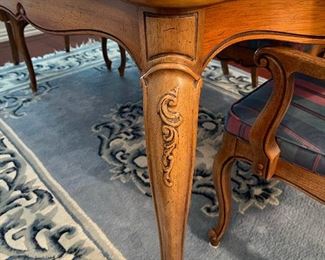 The leg detail of the dining table, beautiful blue and white wool rug