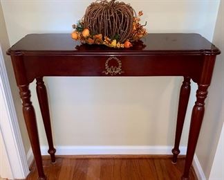 Small console table with faux drawer.