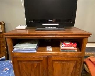 Magnavox smart tv and oak stand.