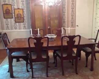 Banded dining table with six upholstered chairs all in excellent condition. Table has two leaves.