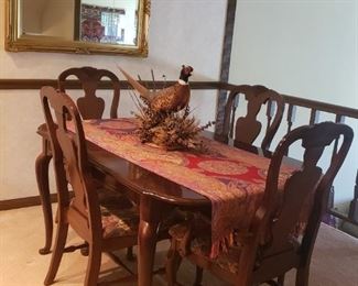 Dining set has an additional leaf and protective coverings