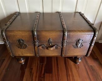 Vintage Wooden Steamer Trunk on Jacobean Legs    1920s-1930s Steamer Trunk with Brass Hardware and Oversized Nailhead Trim.  Leather Straps on Front, Sides, and Top of Trunk.  All in Nearly Mint Condition. 
See pictures for details and condition.