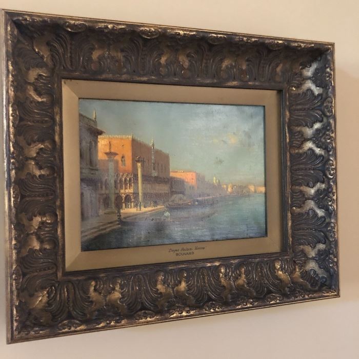 Oil Painting of the Doges Palace by Bouvard - Antoine Bouvard was a French landscape artist who notably often painted under the pseudonym Marc Aldine. Bouvard remains best known for his renderings of Venetian canal scenes, painted in warm tones and a hazy light that often accompanies the setting of the sun. A typical work is A Gondolier Before a Venetian Bridge, depicting the grand canal of the famous Italian city in a realist style that remained popular with tourists throughout his career. He was notably influenced by the French painter Félix Ziem, who was also popular for his poetic depictions of maritime scenes and port cities. Bouvard was born in 1870 in St. Jean-de-Bournay in L'Isere, France, and went on to study at the Academy of Beaux-Arts in Paris, befriending the French architect Constant-Dufeux who helped shape his career and aesthetic. He eventually became the director of architectural services for the Seine in tandem with his painting career, and is accredited with the cons