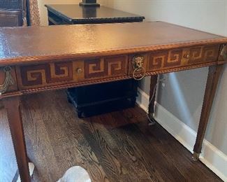 This beautiful desk has a leather inlay top