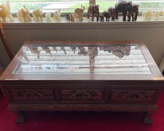 Vintage Heavy Deep Carved Oriental Glass Top Teak Coffee Table with Three Drawers Also Carved, Assorted Hand Carved Elephants, Alabaster, Wood & Soap Stone