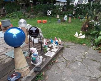 Outdoor yard art. Gnomes.  Numerous shepard's hooks and assorted hanging items.  Aluminum wash tubs.  Copper brass tubs planted.  