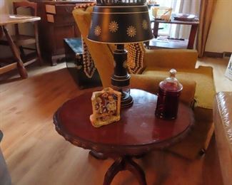 Oval mahogany  table with lamp and small vintage figurine of children on a swing. 