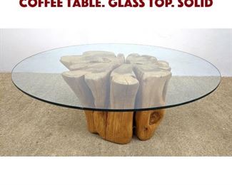 Lot 1003 Natural form Tree Trunk Coffee Table. Glass Top. Solid 