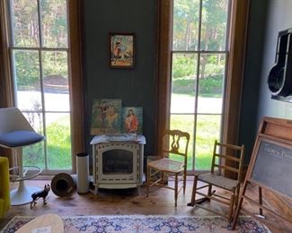 MCM gas burning stove, primitive chairs, 1970s stool, carpet.