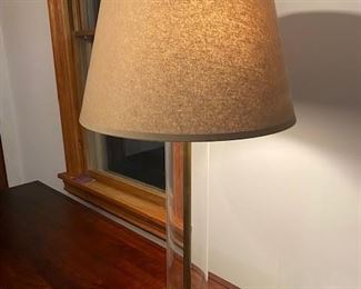 TABLE LAMP BY RESTORATION HARDWARE, ANTIQUE BRASS FINISH WITH GRAY LINEN SHADE. THE SHADE IS STAINED ON ONE SIDE