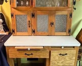 Hoosier cabinet with swing out stool
