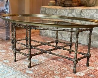 Faux tortoise bamboo cocktail table with brass-rimmed glass topper. Measures 44.5"W x 13" H x 31" D. Photo 1 of 3. 