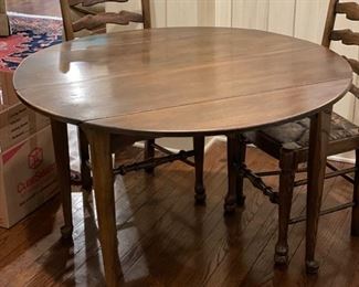 Drop-leaf dining table. Measures 43.5" D x 28" H. It's 27" W with both sides down and extends to 63.5" oval shape with two 10" leaves. Photo 1 of 2. 