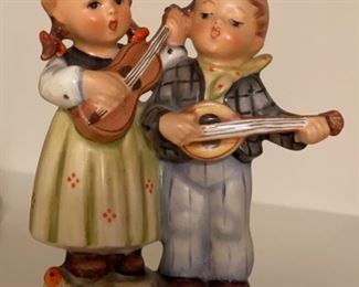 Hummel figurine of girl and boy playing violin and mandolin. 