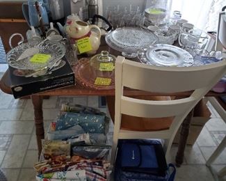 Large assortment of tablecloths and vintage glassware