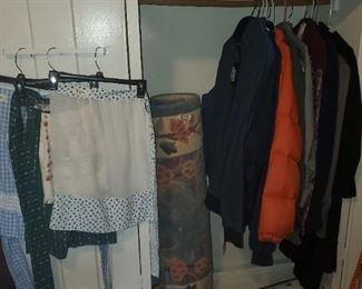 More clothes and rugs and a metal closet