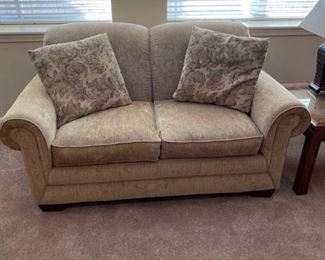 Beige upholstered love seat