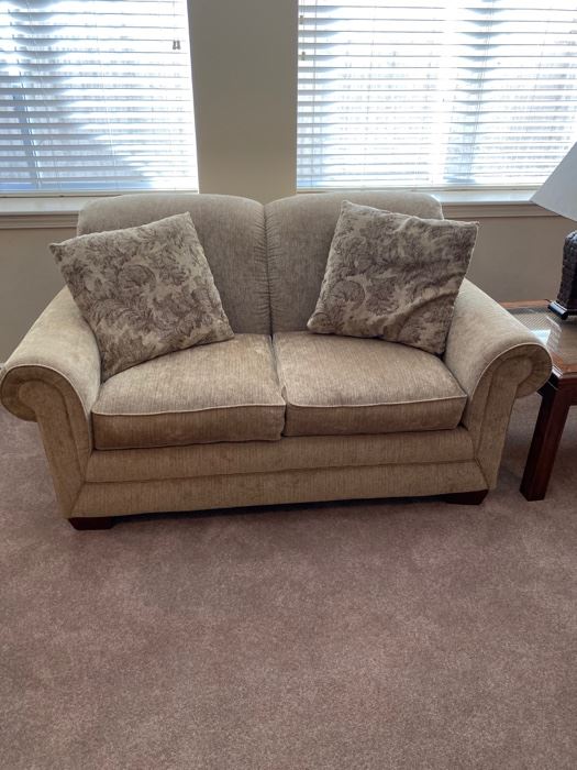 Beige upholstered love seat