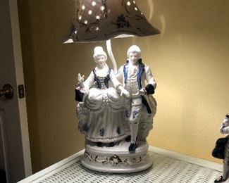 Beautiful, unique porcelain lamps that accent the white wicker bedroom set 