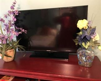 another samsung tv with beautiful flower arrangements