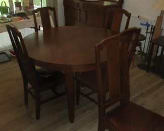 Arts and crafts mission style round dining table with chairs and leaves