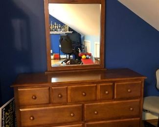 Solid wood dresser complete with mirror. Mirror is 42"H x 28"W. it rests atop this 7-drawer dresser that measures 32"H x 18"D x 56"W