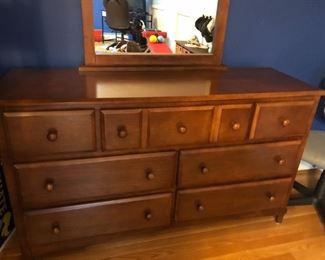 Solid wood dresser complete with mirror. Mirror is 42"H x 28"W. it rests atop this 7-drawer dresser that measures 32"H x 18"D x 56"W