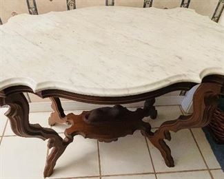 #27 - $695 - Circa 1860's  walnut turtle top table, original marble tops, ogee edging, with reclining dog on base.   • 28high 36wide 22deep