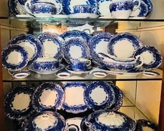 #28 - Wedgwood "Atalanta"  Flow blow semi-porcelain dinner set with gold edges
.
Scroll to view list:
4 nesting platters
- Small platter  • 9“ x 6 1/2 
-largest platter  • 16 x 12
1 oblong covered sever  • 5high 12 across
1 round covered server  • 5high 10across
1 round covered strainer dish  • 8across
1 gravy boat with saucer  • 9across
1 cream pitcher  • 4 1/2 high 5across
1 sugar bowl  • 4high 7across
1 open To handleserver  • 3high 9across
7 cups 
10 saucers  • 6across
17 finger bowls  • 3 1/2across
12 salad plate • 7across
5 shallow flange bowls  • 8across
13 soup bowls • 8across
12 berry bowls • 5across 