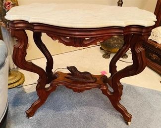 86B - $695 - Another one, slightly different Circa 1860's  walnut turtle top table, original marble tops, ogee edging, with reclining dog on base.  • 29high 31across 20deep  