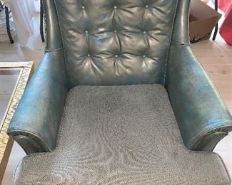 Comfortable large leather easy chair with reupholstered fabric cushion