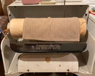 Iron out all those wrinkled clothes with this vintage Ironrite machine!