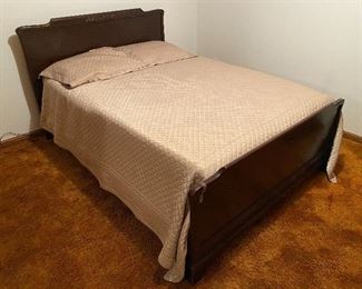 Full-size bed with mattress and box.