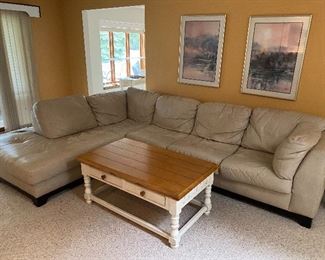 Leather sectional couch; cottage-style cocktail/coffee table.
