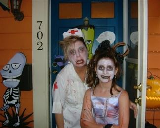 Mae and me on Halloween 2012. I'm a zombie nurse and Mae is a zombie prom girl who died getting trampled on by the horse carriage taking her to prom. (That's a horseshoe embedded in her head.) (I'm so proud.)