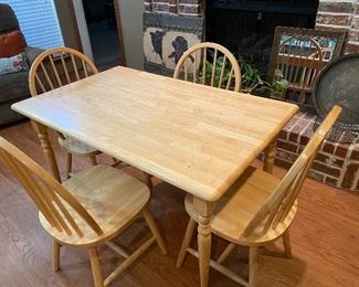 Simple little light wood table & 4 chairs. Great for that first apartment.