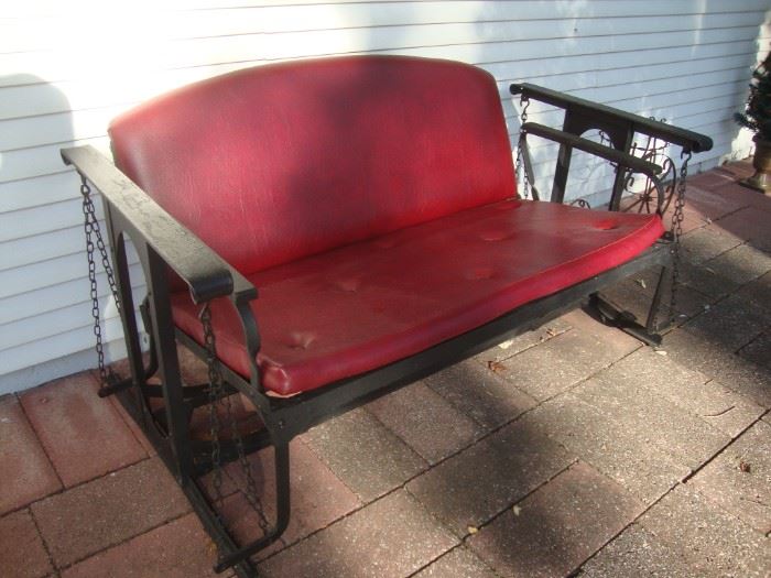 Antique glider with newer vinyl upholstery
